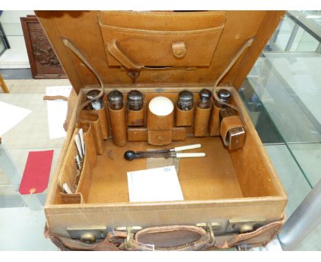 A VINTAGE LEATHER LADIES TRAVELLING CASE BY S.FISHER, LONDON CONTAINING SILVER TOPPED BOTTLES,ETC TOGETHER WITH A VICTORIAN L