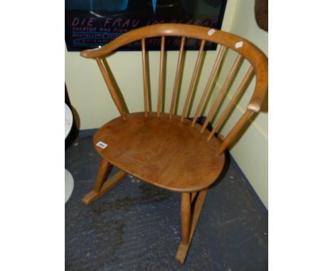 AN ERCOL PALE ELM COTTAGE SMALL ROCKING CHAIR WITH BS1960 STAMP.