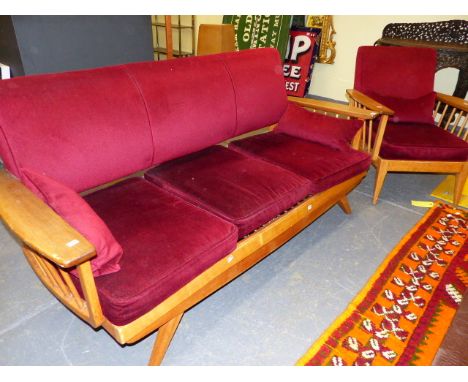 A MID CENTURY THREE PIECE SUITE COMPRISING A THREE SEATER SOFA AND TWO ARMCHAIRS WITH SPINDLE SUPPORT ARMS.  (3)