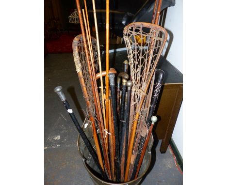 A BRASS GRAPE HOD CONTAINING STICKS, FISHING RODS, SCABBARDS AND BLADES TOGETHER WITH A FLOOR STANDING HOOKAH PIPE.