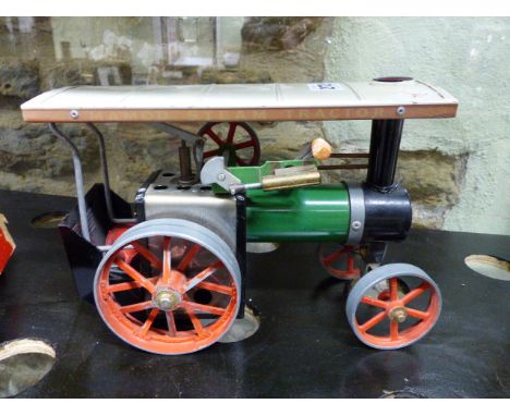 A MAMOD STEAM TRACTION ENGINE TOGETHER WITH A HORNBY No.1 O GAUGE CLOCKWORK LOCOMOTIVE.