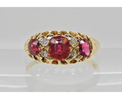 An 18ct gold ruby and diamond ring dated Birmingham 1915, central ruby is approx 5.5mm x 4.8mm x 3mm, flanked by four 0.02ct 