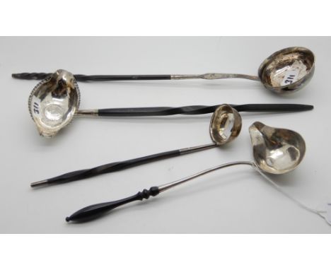 A lot comprising a punch ladle with coin set bowl and whale bone handle and three other toddy ladles (4) Condition Report: Av