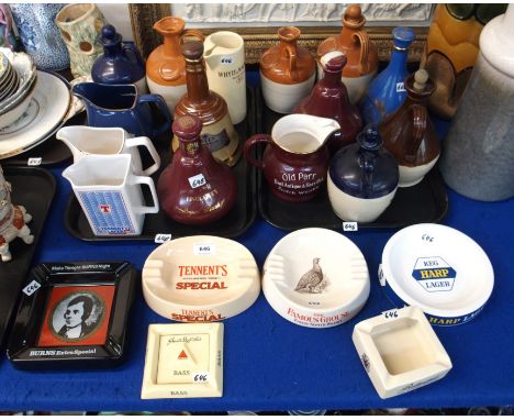 A collection of whisky decanters, water jugs and advertising ashtrays including Old Parr Scotch Whisky jug, Tennants jug, Fin