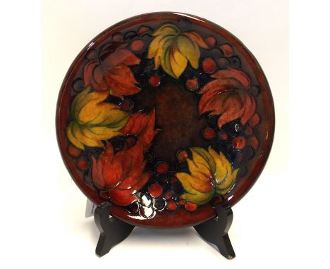 A Moorcroft flambe 'leaf and berry' pattern dish, 22cm diameter Condition Report: Is crazed and has a few deep scratches .