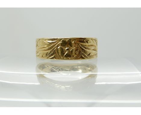 An 18ct gold wedding band with floral engraving, size L1/2, weight 5.3gms Condition Report: Light general wear. 