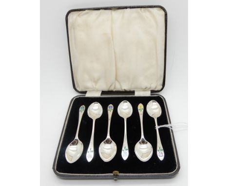 A cased set of six silver coffee spoons with floral enamel decorated terminals, Birmingham 1938 Condition Report: Available u