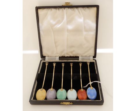 A cased set of six silver gilt and enamel seal-top coffee spoons, Birmingham 1928 Condition Report: Available upon request