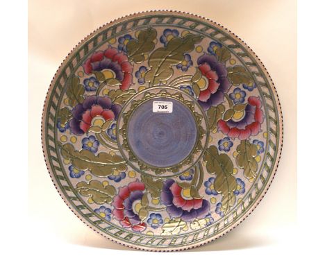 A Charlotte Rhead for Crown Ducal charger, with tubelined decoration of pink and purple flowers and foliage, 45cm diameter, s