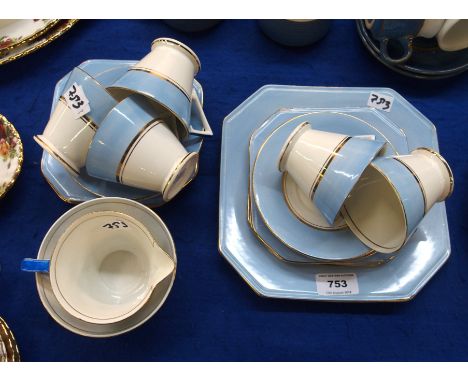 A Palissy Deco style part teaset with blue, white and gilt decoration Condition Report: only 5 cups and saucers. Has crazing 