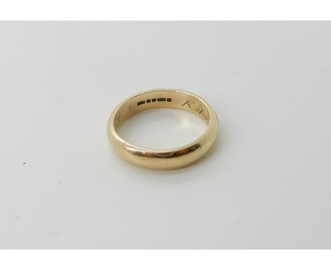 A 9ct gold wedding band inscribed to the inner shank size K, weight 2.9gms Condition Report: Light general wear, inner shank 
