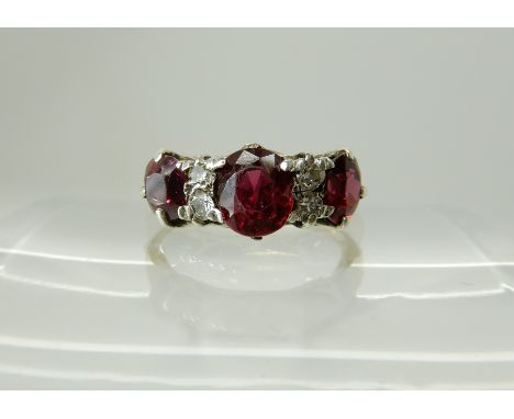 an 18ct gold diamond and ruby ring, size O1/2, weight 3.1gms Condition Report: Claws need attention on middle stone , its loo