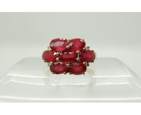 A 9ct gold ruby and diamond cluster ring, size O, weight 3.7gms Condition Report: Light general wear, rubies heavily treated,