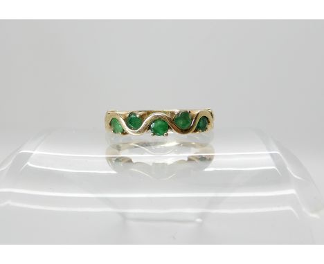 A 9ct gold emerald set wiggle design ring size M, weight 2.4gms Condition Report: Light general wear, some surface reaching f