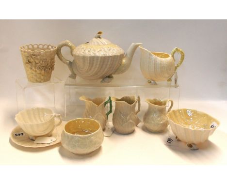 A Belleek Neptune yellow teapot, 14.5cm high, milk jug and sugar bowl, cup and saucer, two Lily pattern jugs, 9cm high, baske