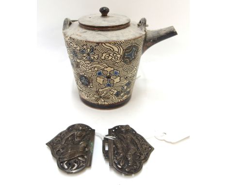 A Burmese white metal buckle, 9cm wide and Japanese pottery teapot, 20m high including handle (2) Condition Report: Available