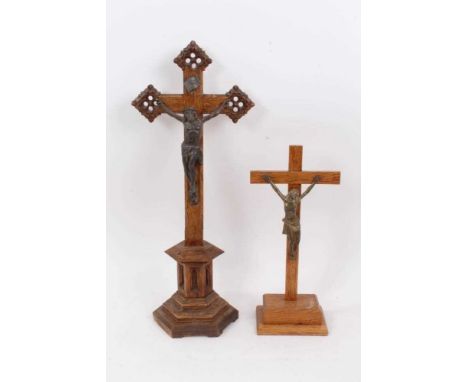Two carved wooden crucifixes, the first probably early 20th century with bronzed Christ figure on carved oak cross with hexag