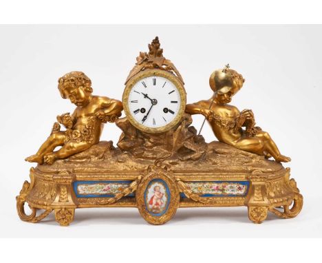 19th century French gilt brass mantel clock with inset porcelain panels, twin putti mounts and central white enamel dial, 46c