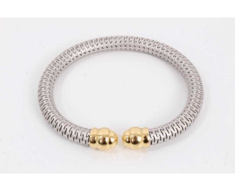 18ct white and yellow gold torque bangle with 'puzzle' links, retailed by Berridges of Ipswich.Excellent condition, total gro