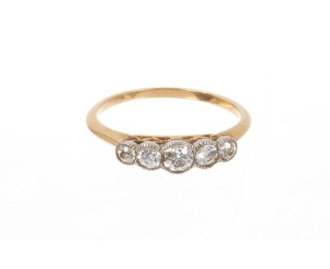 Edwardian diamond five stone ring with five graduated old cut diamonds in platinum millegrain setting with pierced gold galle