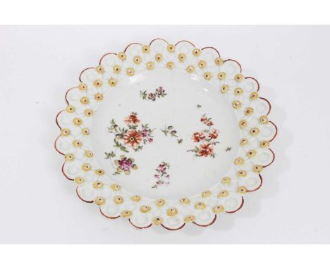 A Derby small plate, circa 1758, the basket moulded border applied with flower heads, polychrome painted with floral sprays, 