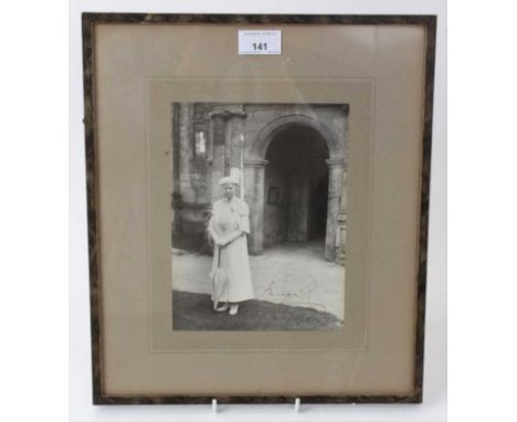 H.M.Queen Mary, signed presentation portrait photograph of The Queen dressed in white including matching hat and umbrella out