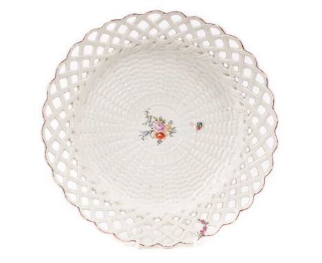 A Chelsea basket moulded round plate, circa 1755, polychrome painted with a floral spray and an insect, red-lined rim, 24cm d