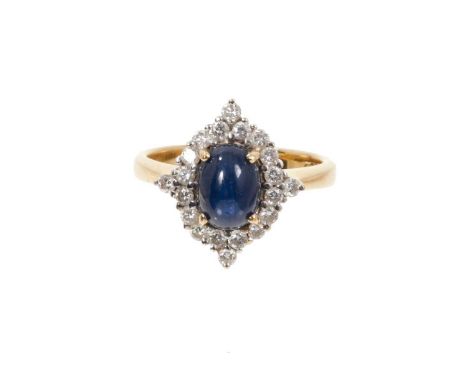 Cabochon sapphire and diamond cluster ring with an oval cabochon blue sapphire measuring approximately 8.15mm x 6mm surrounde