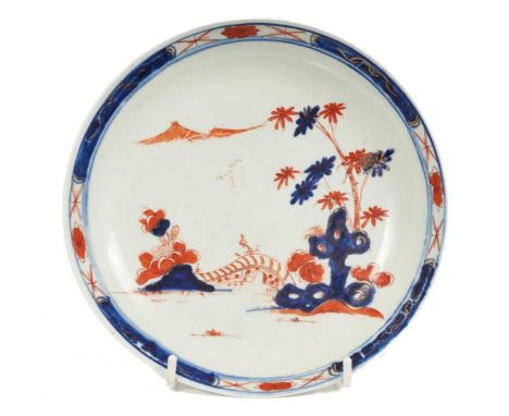 A Vauxhall saucer dish, circa 1760, painted in the Imari style with a Chinese landscape, 19cm diameter Some scratches, enamel