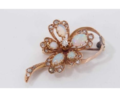 Edwardian opal and diamond floral spray brooch with central old cut diamond surrounded by cabochon opals and rose cut diamond