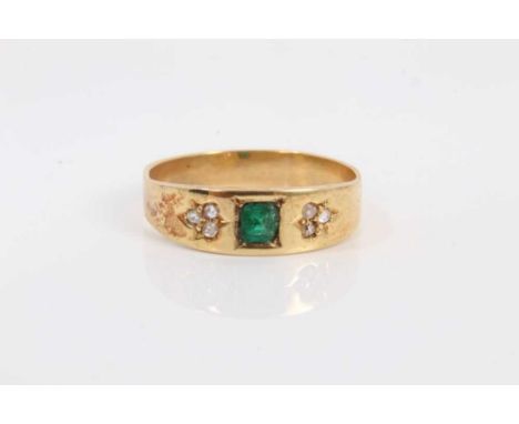 Edwardian emerald and diamond ring with central cushion shaped step cut emerald flanked by three rose cut diamond clusters to