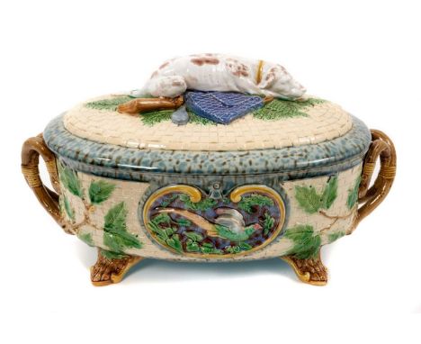 A Victorian Minton majolica game pie dish and cover, of oval form, the cover modelled with a gun dog, the outside decorated w