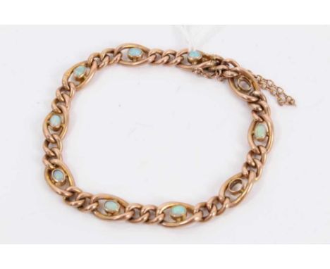 Edwardian 9ct rose gold curb link bracelet set with eight opal cabochons (two missing), 18cmWeight 8.6 grams