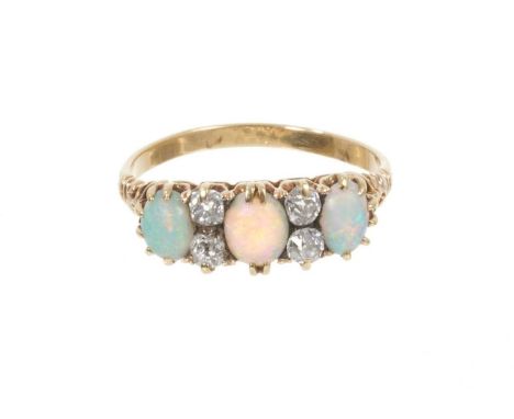 Late Victorian opal and diamond ring with three oval cabochon opals interspaced by four old cut diamonds in gold claw setting