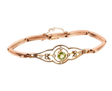 Edwardian 9ct gold peridot and seed pearl bracelet with an open work panel set with a central round mixed cut peridot and ten