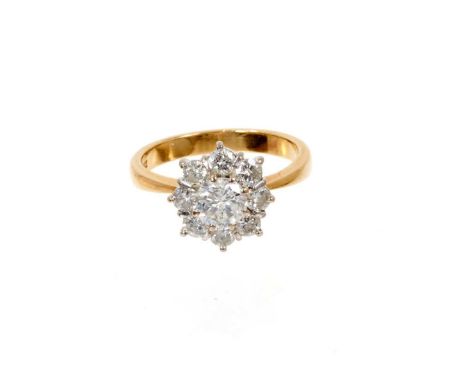 Diamond cluster ring with a flower head cluster of nine brilliant cut diamonds, estimated to weigh approximately 1ct, in claw