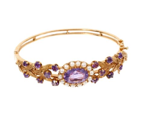 Victorian style 9ct gold amethyst and cultured pearl hinged bangle with a central oval mixed cut amethyst surrounded by a bor