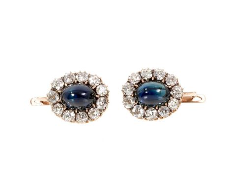 Pair of antique sapphire and diamond cluster earrings, each with a natural blue cabochon sapphire measuring approximately 9mm