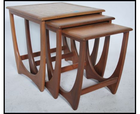 A 1970's G-Plan Kelso teak and tile top nest of tables. The tables of graduating form with tiled large table, plain smaller t