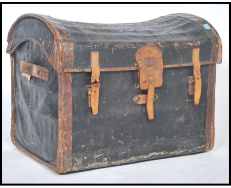 A Victorian leather and canvas bound whicker dome top steamer trunk having hinged top with monogram to centre. The interior w