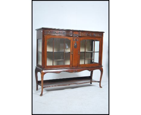 An Edwardian mahogany chiffonier display cabinet raised on shaped legs with glass display cabinet with an open tier shelf  be