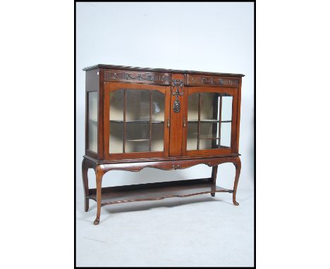 An Edwardian mahogany chiffonier display cabinet raised on shaped legs with glass display cabinet with an open tier shelf  be