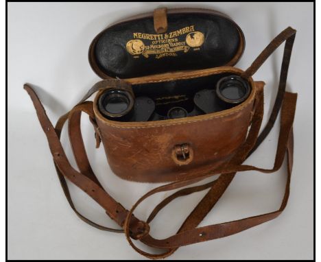 A pair of vintage early 20th century leather cased Carl Zeiss Jena binoculars DF 6x. The leather case interior marked for Neg