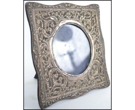 A Victorian silver hallmarked rococo photograph frame with easel back. Hallmarks not visible. Loss to one side, not immediate