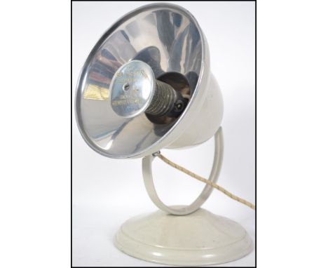 A vintage retro 20th century industrial Barber Polykymatic heat generator anglepoise lamp in white raised on a circular base 