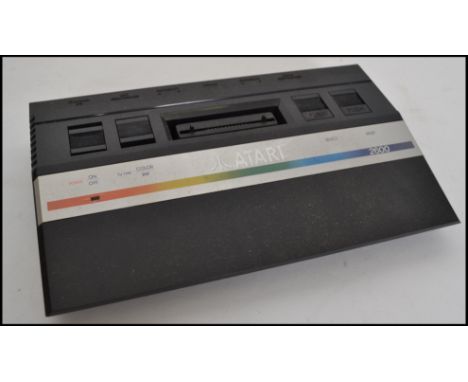 A vintage Atari 2600 games console complete with many games to include Centipede, Mrs Pacman, Pole Position, Midnight Magic, 
