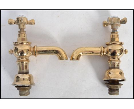 A pair of vintage 20th century Victorian style brass bathroom taps by Adams and Sons.