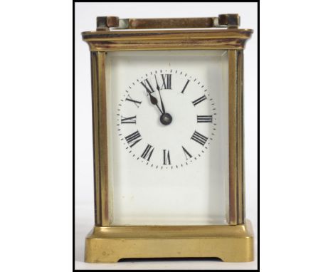 An 20TH century brass cased  column carriage clock having five bevel edged glass panels, enamel dial with Roman numeral chapt