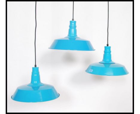 A set of three contemporary retro vintage style enamel ceiling pendant light fixtures. Having a turquoise blue enamel finish 