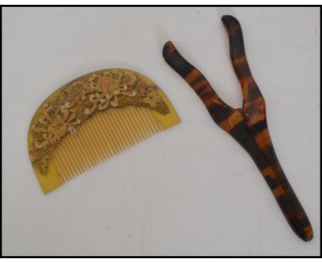An Art Deco Japanese celluloid hair comb decorated with gilt overlay floral decoration together with a celluloid pair of glov